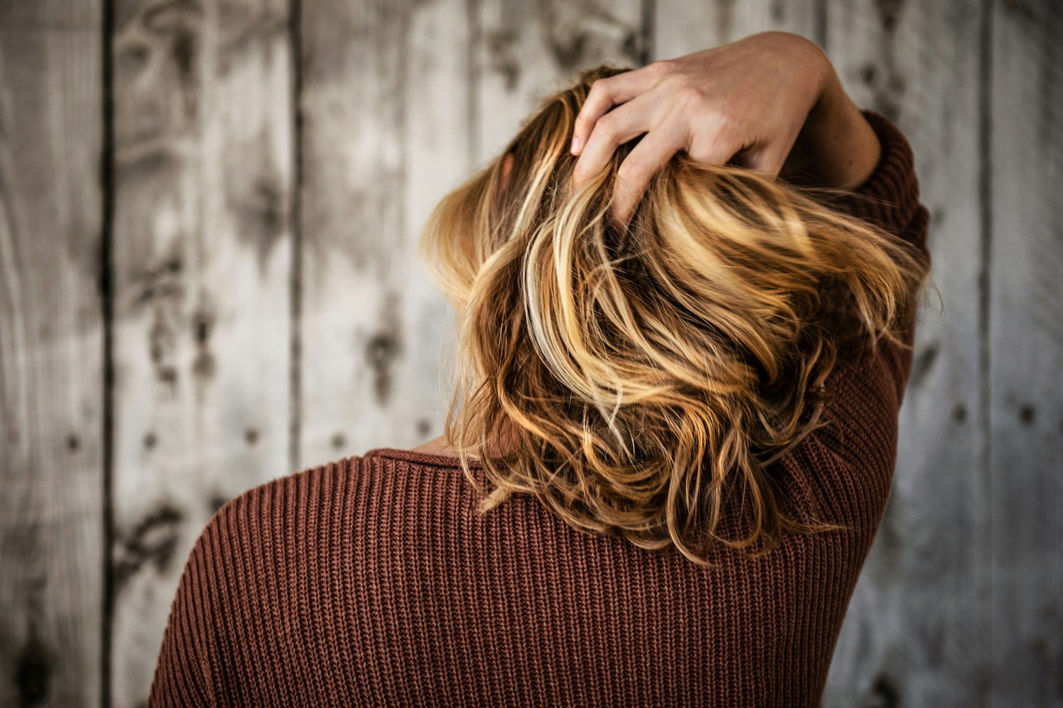 a-woman-fixing-her-hair-for-a-stylish-look