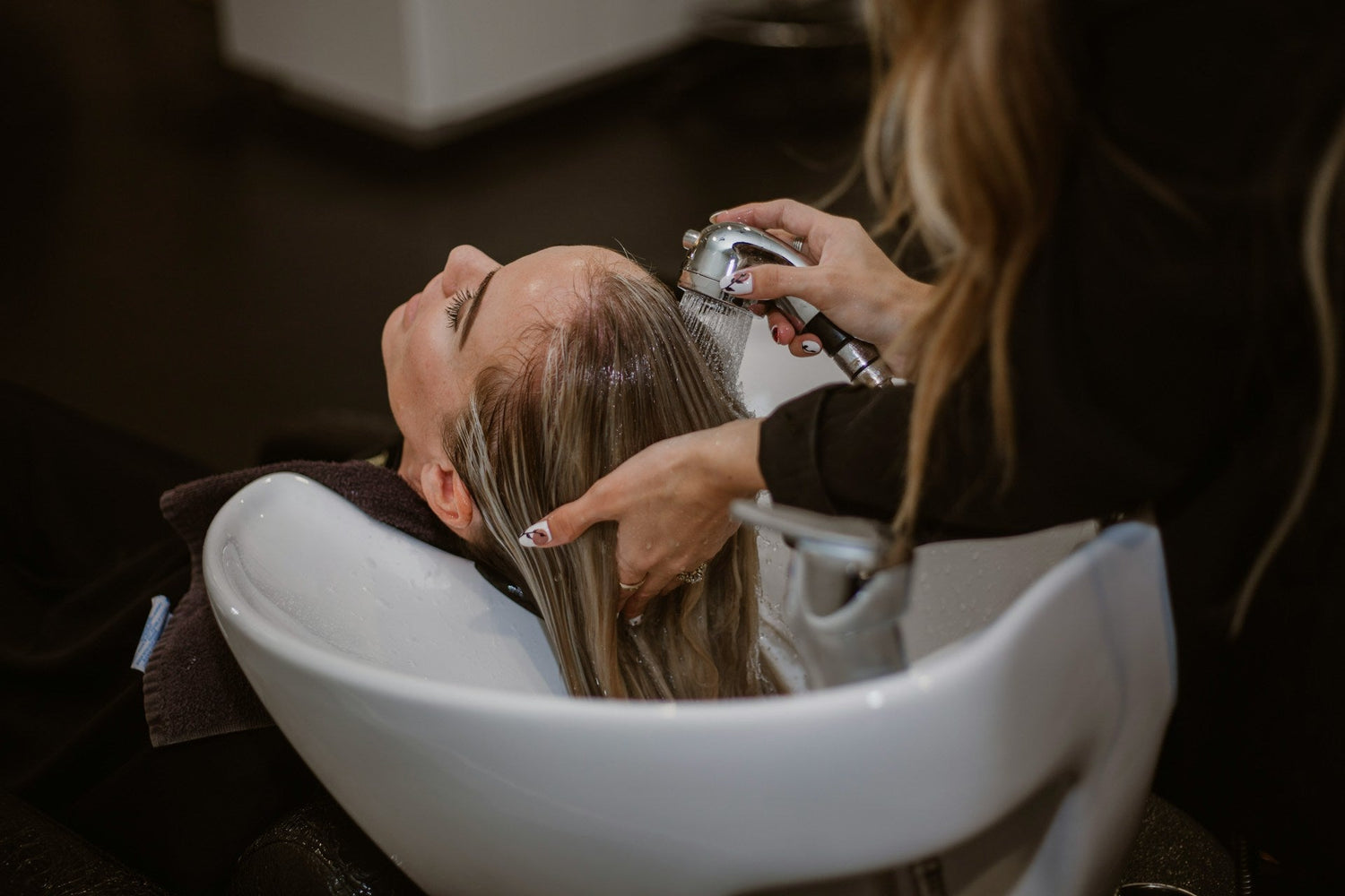 woman-receiving-hair-care-treatment-for-healthy-and-shiny-hair